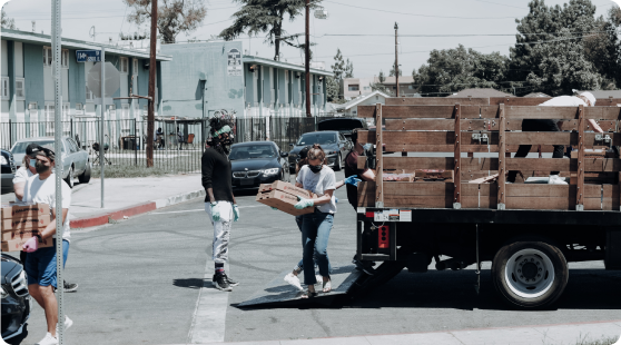 Personas descargando aguacates de un camión